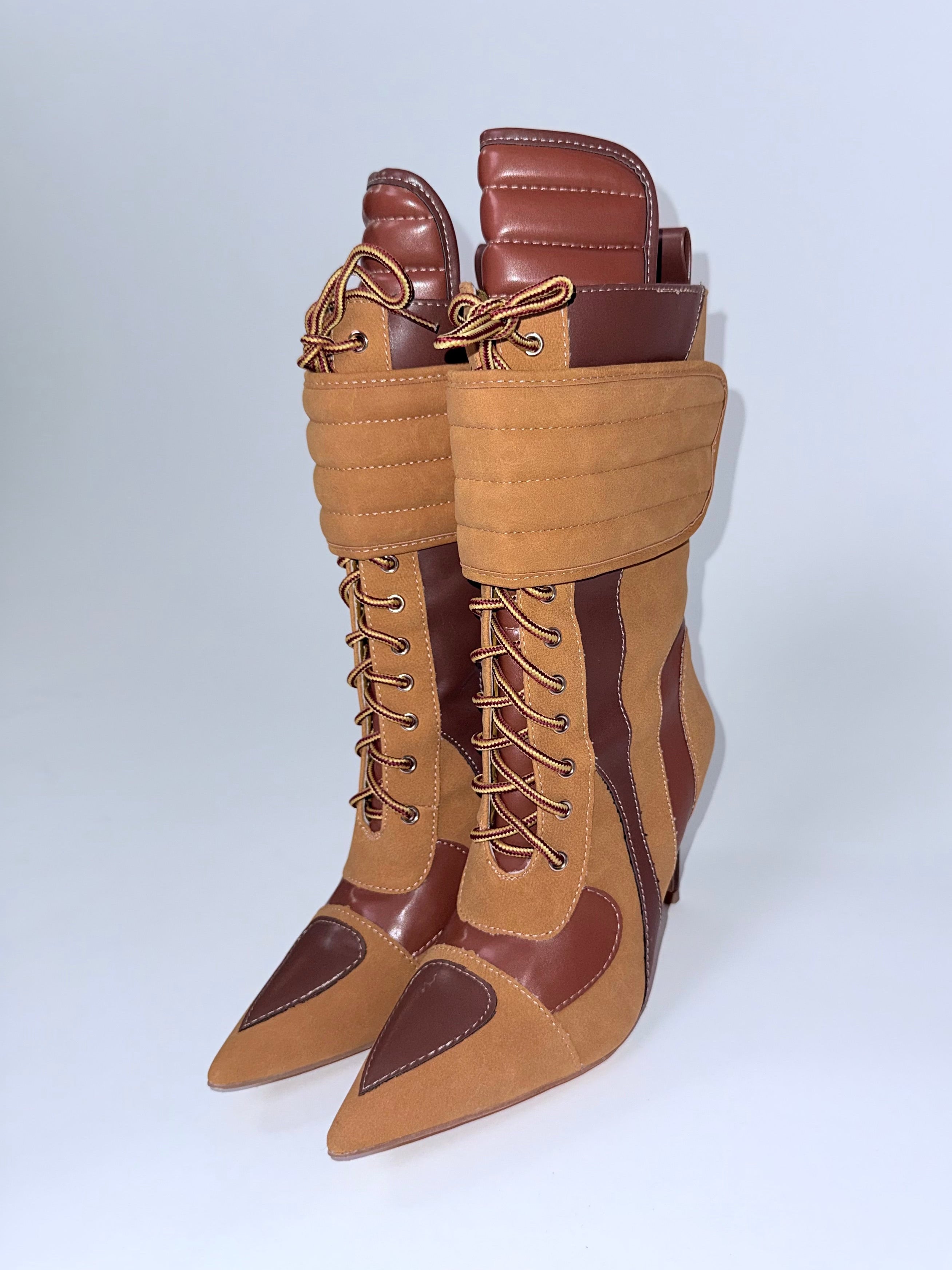 Tan and brown lace-up boots on a white background
