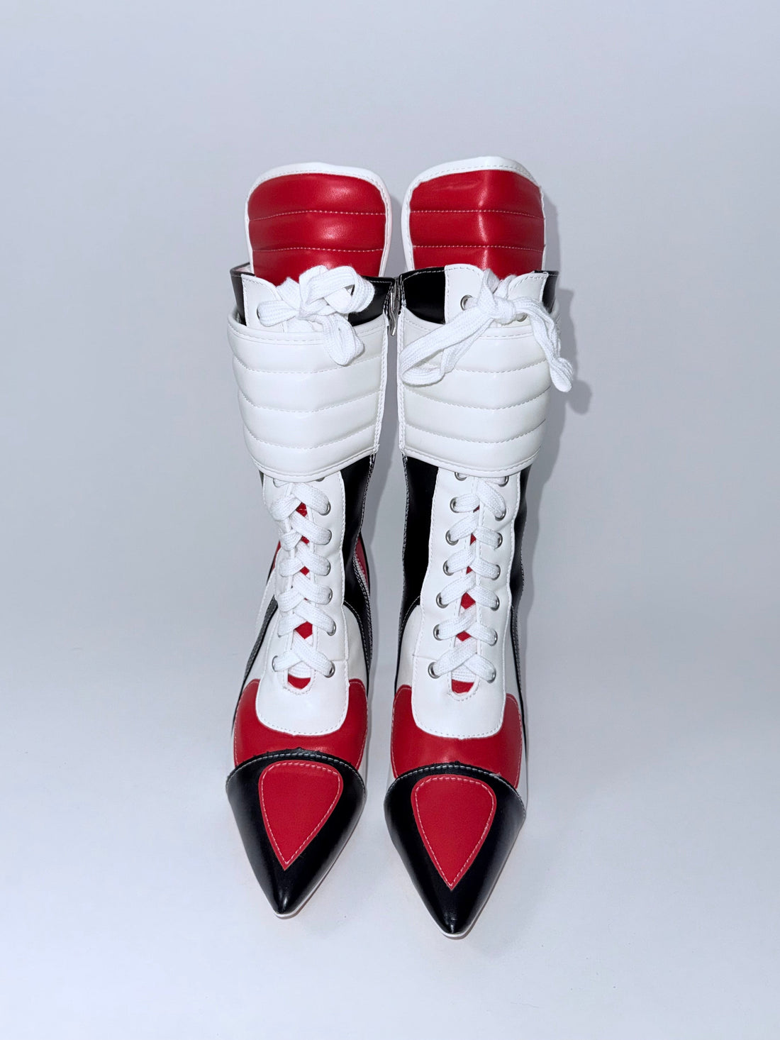 Pair of red, white, and black Y2k high-heeled shoes on a light gray background